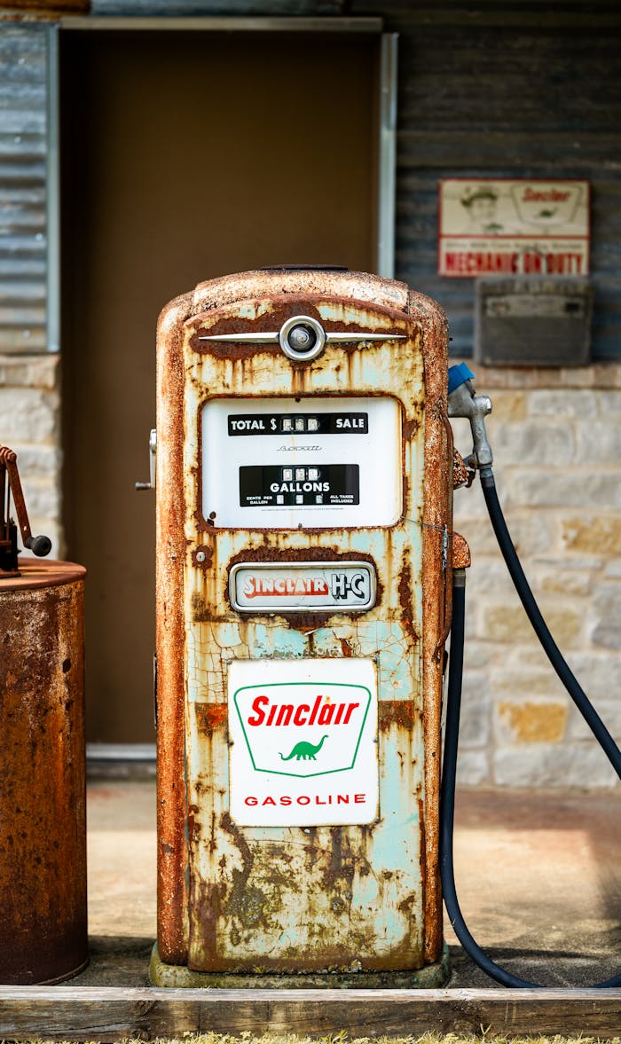 Rustic Sinclair gasoline pump with weathered texture, evoking vintage charm in a nostalgic setting.